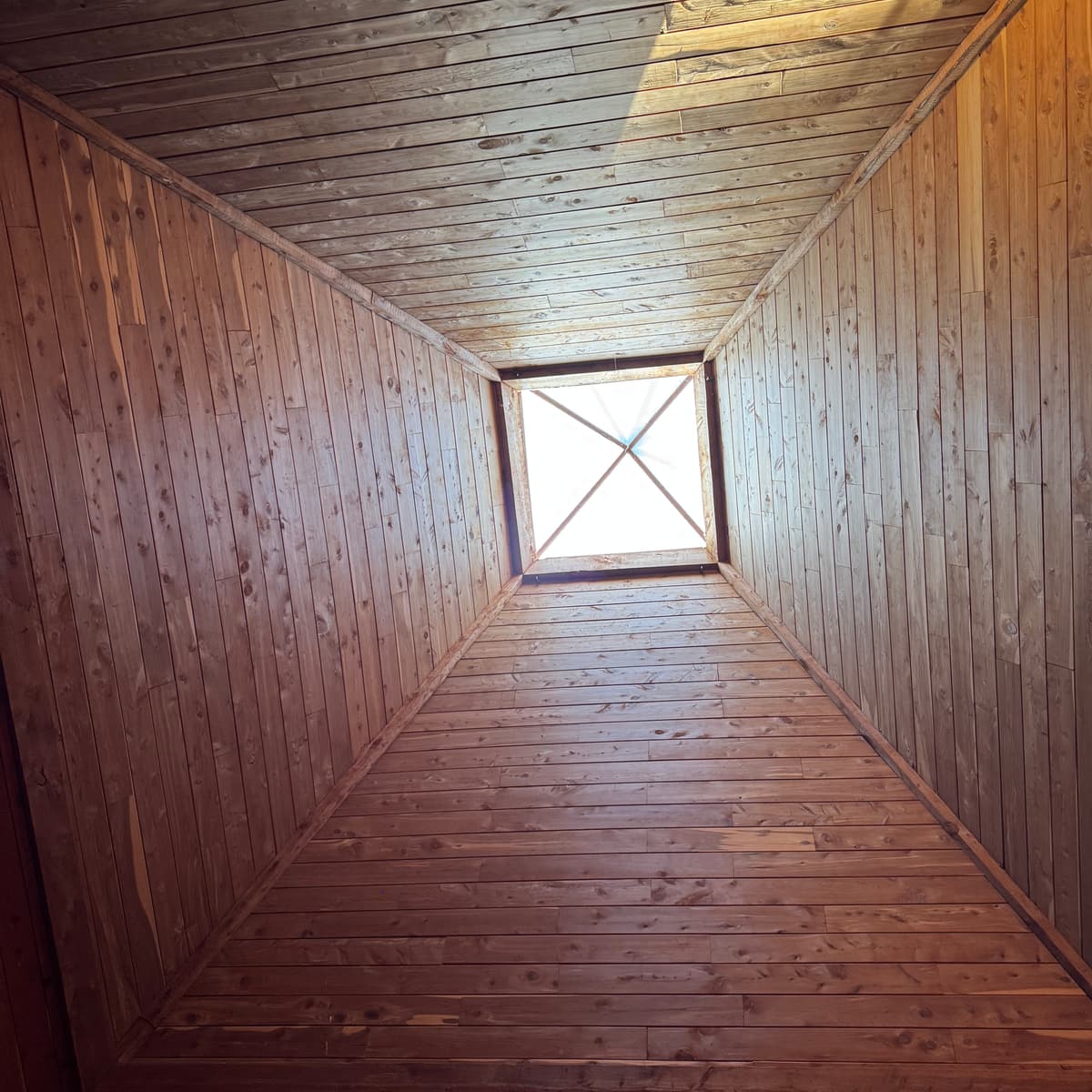 Looking straight up the cedar walls of the pyramid to the skylight at its peak.